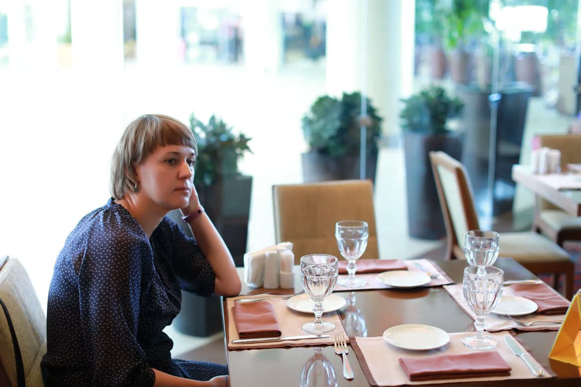 Thinking woman in restaurant